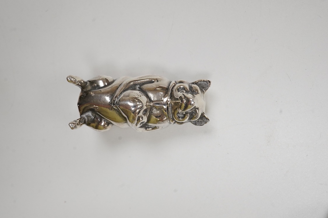 A George V silver mounted fan pin cushion, Henry Matthews, Birmingham, 1912, width 62mm, together with an Edwardian silver vesta case and a white metal pig vesta case.